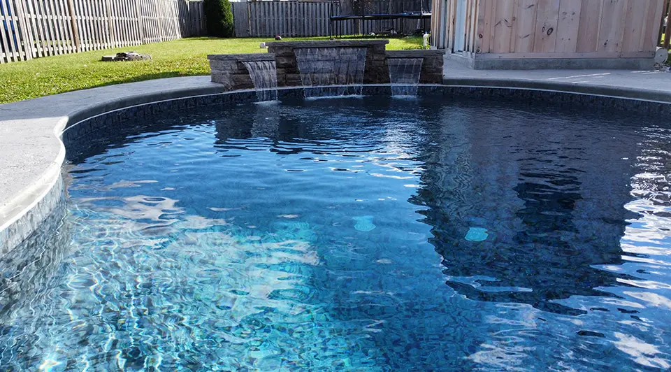 A family vinyl pool in Brookside with a concrete surround and pool toys