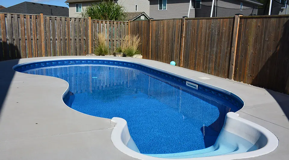 A deep blue vinyl pool at Noble residence with crystal-clear water