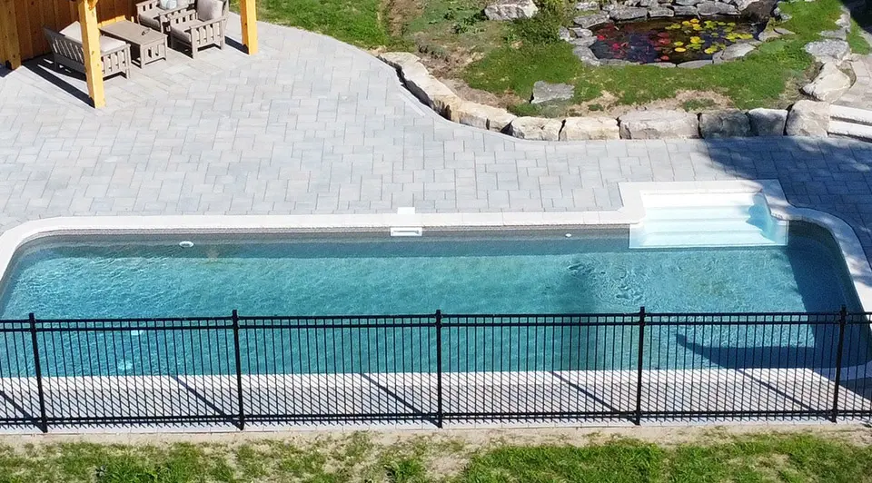 A beautifully lit vinyl pool at sunset with warm amber light on the water