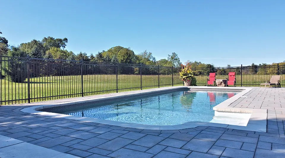 Evening shot of a vinyl pool with glowing underwater lights during sunset