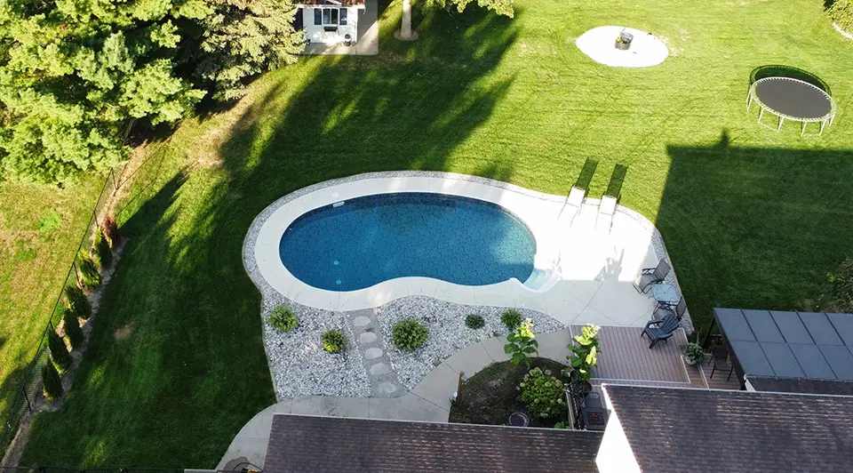 A vinyl pool in Talbotville with crystal-clear water and a well-maintained deck